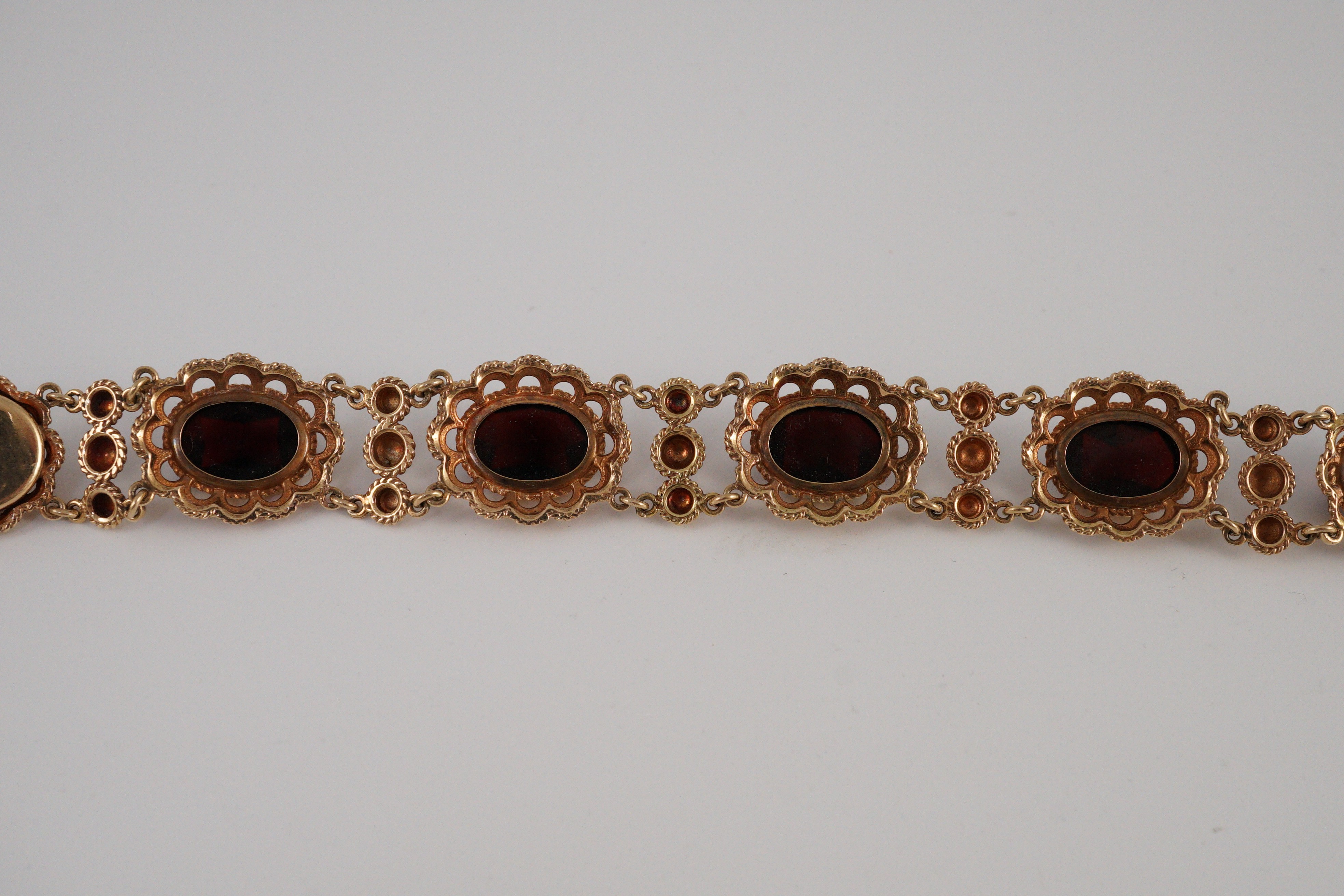 A 20th century Dutch 14k gold and six stone facet cut cabochon garnet set fancy link bracelet